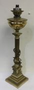 A tall brass oil lamp on step base with bead work