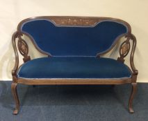 A Victorian inlaid saloon settee decorated with fl