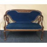 A Victorian inlaid saloon settee decorated with fl