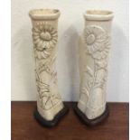 A pair of ornate trench art carved tapering vases.