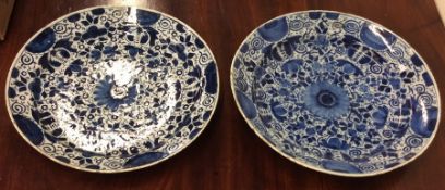 Two large blue and white Delft chargers with flora