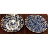 Two large blue and white Delft chargers with flora