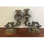 A pair of good quality brass candlesticks decorate