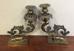 A pair of good quality brass candlesticks decorate