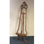 An unusual gilt easel on scroll supports. Est. £50