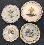 A group of four Quimper side plates decorated with