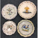 A group of four Quimper side plates decorated with