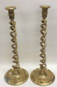 A tall massive pair of brass candlesticks of barle