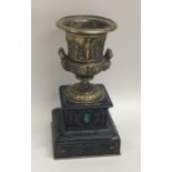 A brass mounted campana shaped vase on slate and m