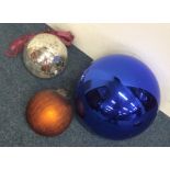 A group of three old witch's balls. Est £60 - £80.
