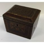 A parquetry tea caddy of shaped form with fitted i