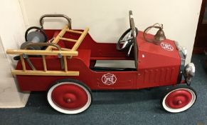 A child's toy fire engine with chrome decoration.