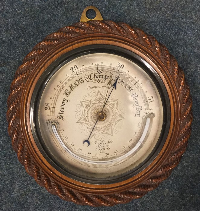 A small oak framed barometer with silvered dial. E