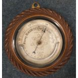 A small oak framed barometer with silvered dial. E