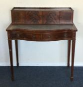 A reproduction serpentine fronted lady's desk. Est