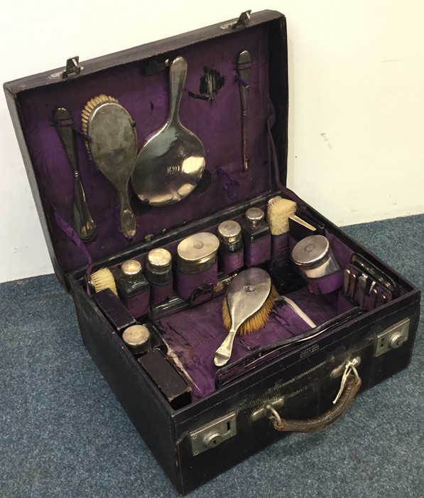 A good quality cased silver travelling vanity set