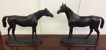 A good pair of bronze figures of horses in standin