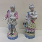 A pair of decorative figures together with a Shell