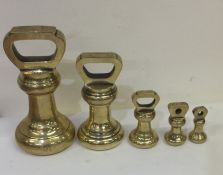 A good set of six tapering brass weights. Est. £70