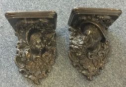 A good pair of carved wall brackets decorated with