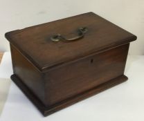 A Georgian mahogany tea caddy / writing box with b