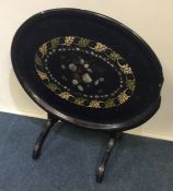 A papier-mâché and MOP inlaid tilt top table. Est.