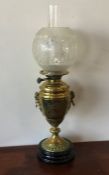 A tall brass oil lamp with etched shade. Est. £30