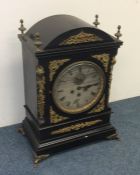 A massive bracket clock attractively decorated wit