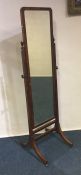 A mahogany dressing mirror on four sweeping suppor