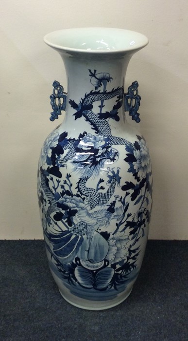 A tall Chinese blue and white vase decorated with - Image 2 of 2