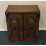 A novelty oak stationery box in the form of a safe