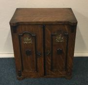 A novelty oak stationery box in the form of a safe