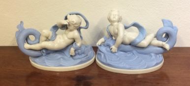 A pair of stylish blue and white figures of childr