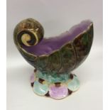 A malachite spoon warmer in the form of a shell to