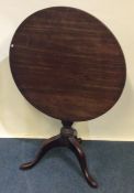 A Georgian mahogany tilt top table on three spread