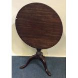 A Georgian mahogany tilt top table on three spread