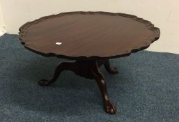 A good mahogany lazy susan on ball and claw feet.