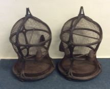 A pair of rare shaped bird cages, the wooden frame