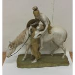 A large Royal Dux model of a horse and rider on re