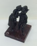 A bronze figure of a dancing couple on square marb
