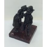 A bronze figure of a dancing couple on square marb