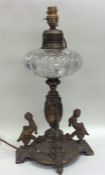 A cut glass mounted oil lamp, the base decorated w