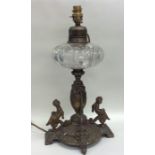 A cut glass mounted oil lamp, the base decorated w