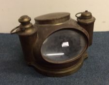 A large brass ship's binnacle with lift-off covers