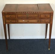 A Victorian sewing table with hinged top on taperi