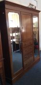 An Edwardian mahogany triple wardrobe with fitted