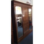 An Edwardian mahogany triple wardrobe with fitted