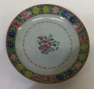 A Chinese plate decorated with flowers and leaves