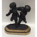 An attractive oval bronze figure of two children o