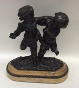 An attractive oval bronze figure of two children o